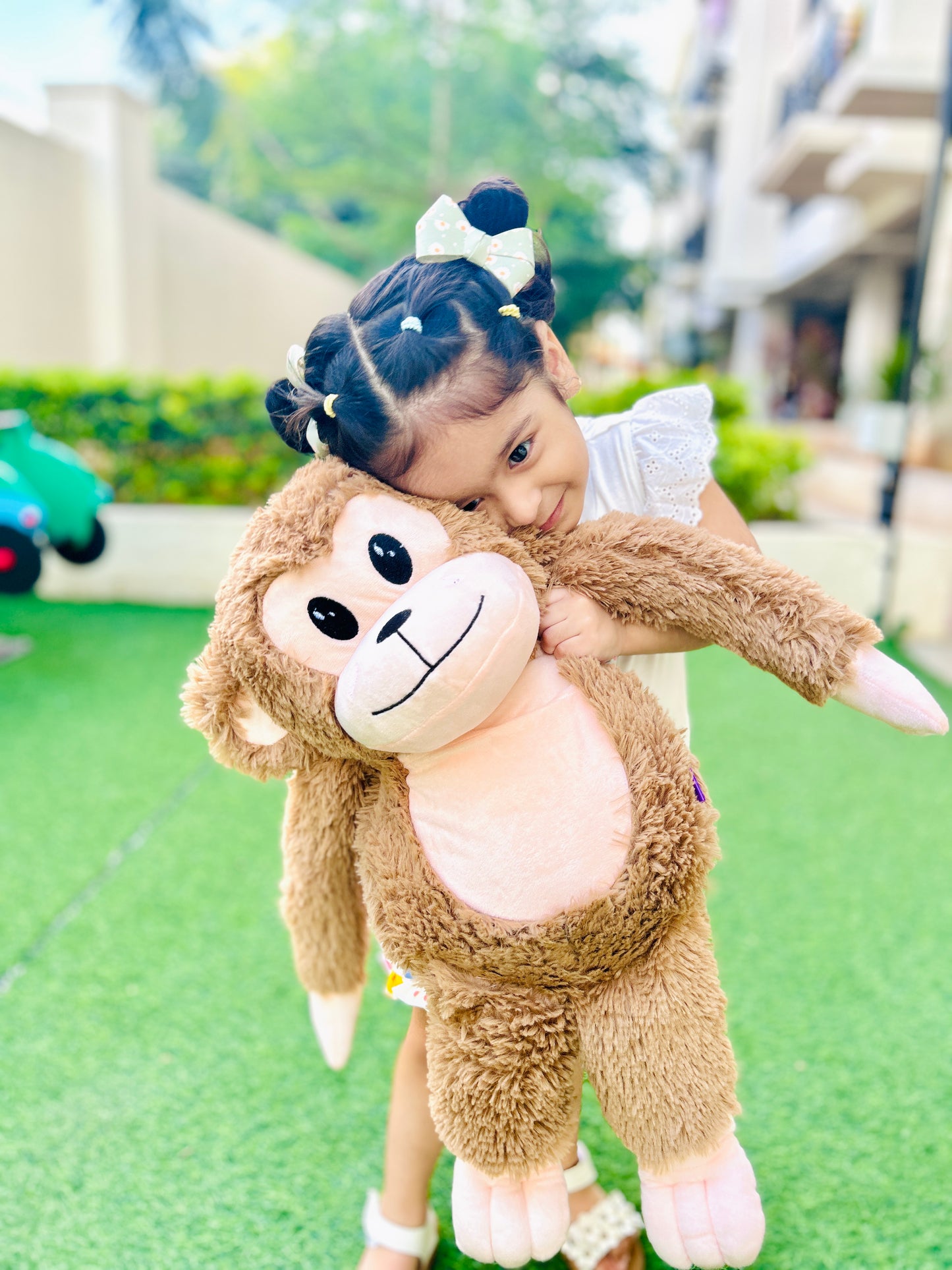 real-life image of kid with big monkey soft toy