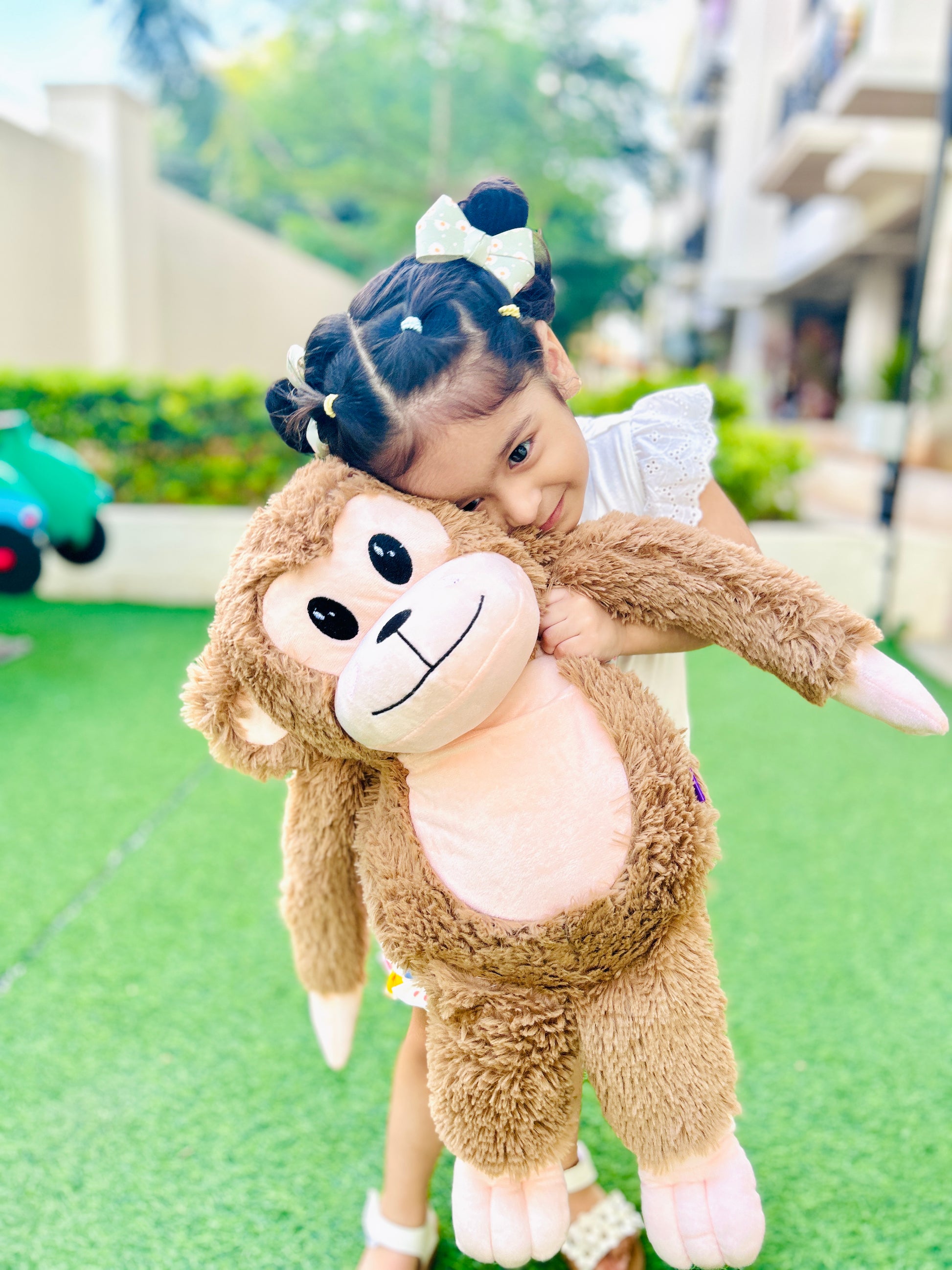 real-life image of kid with big monkey soft toy